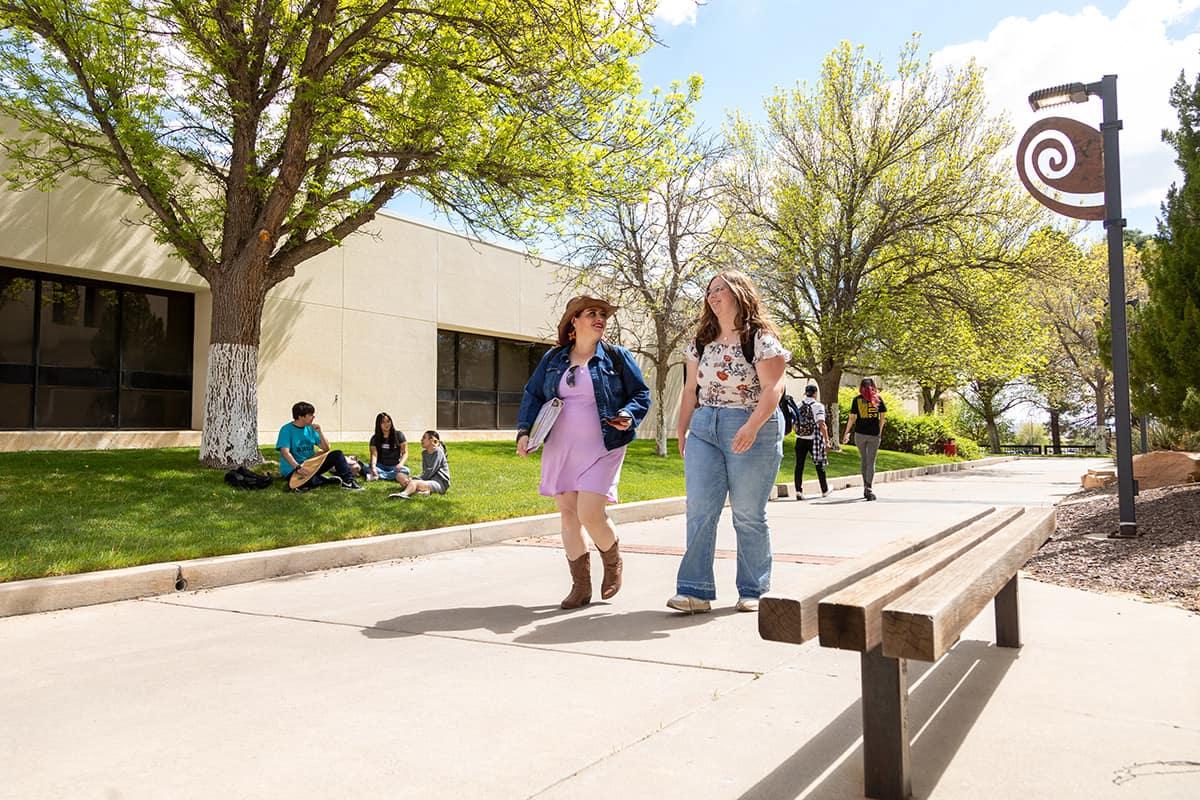 College students walk through campus chatting